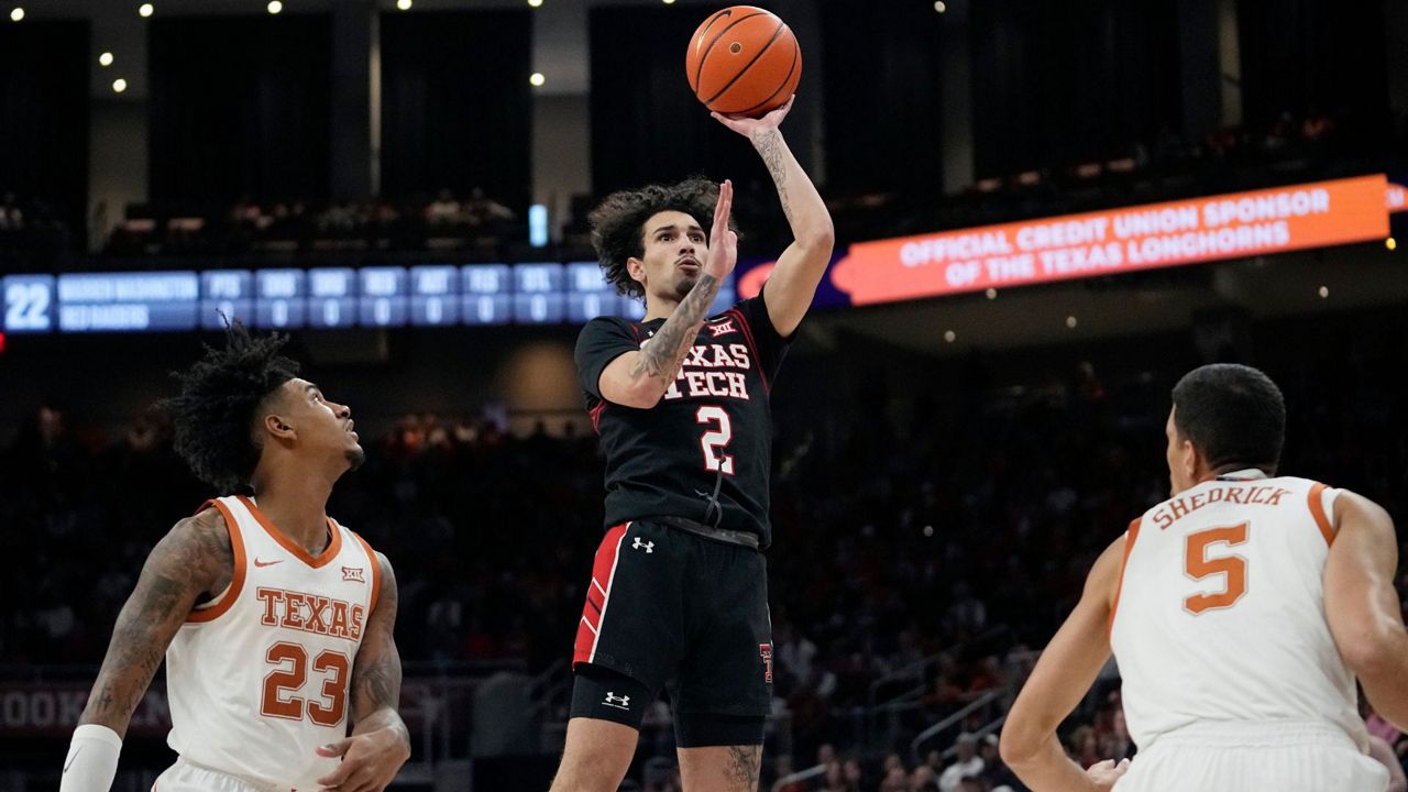 Texas Tech guard Pop Isaacs (2) shoots past Texas forwards Dillon Mitchell (23) and Kadin Shedrick (5) during the first half of an NCAA college basketball game in Austin, Texas, Saturday, Jan. 6, 2024. (AP Photo/Eric Gay)