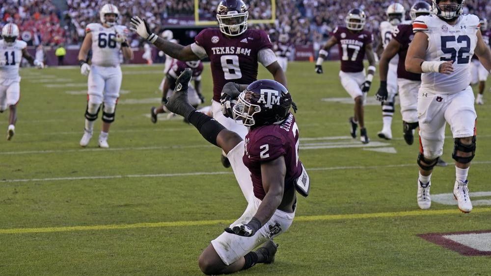 Texas A&M defensive lineman Micheal Clemons (2) falls into the end zone for a touchdown after recovering a fumble by Auburn quarterback Bo Nix during the second half of an NCAA college football game Saturday, Nov. 6, 2021, in College Station, Texas. Texas A&M won 20-3. (AP Photo/David J. Phillip)