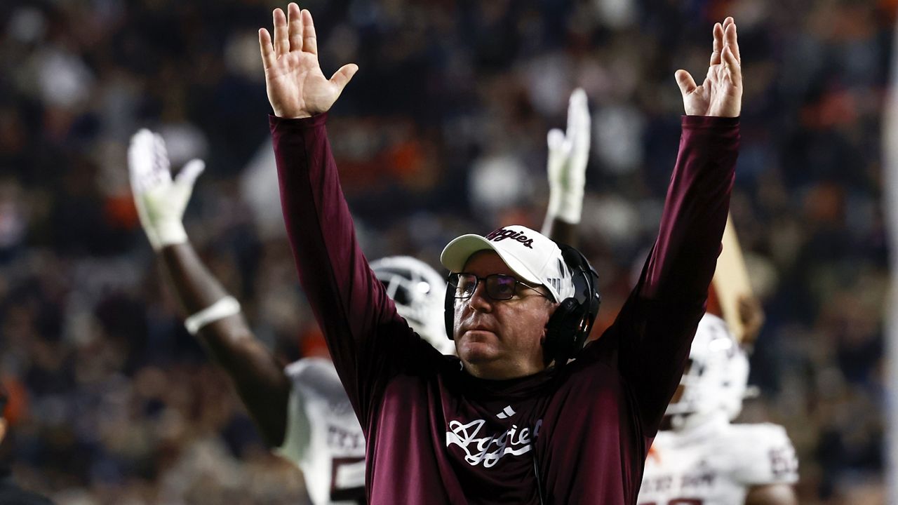 Texas A&M head coach Mike Elko reacts after a touchdown against Auburn during the first half of an NCAA college football game, Saturday, Nov. 23, 2024, in Auburn, Ala. (AP Photo/Butch Dill)