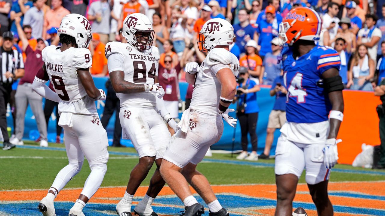 Texas A&M tight end Theo Melin Ohrstrom, second from right celebrates his touchdown reception on a 29-yard pass play with teammate tight end Tre Watson (84) and wide receiver Jahdae Walker (9) as Florida defensive back Jordan Castell (14) walks off the field during the first half of an NCAA college football game, Saturday, Sept. 14, 2024, in Gainesville, Fla. (AP Photo/John Raoux)