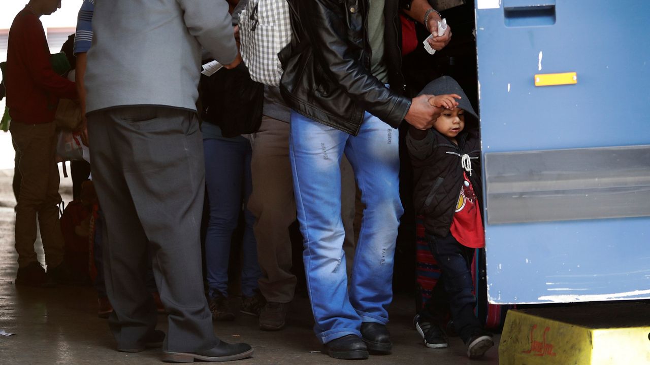 Immigrants from Central America seeking asylum board a bus, Tuesday, April 2, 2019, in downtown San Antonio. (AP Photo/Eric Gay)