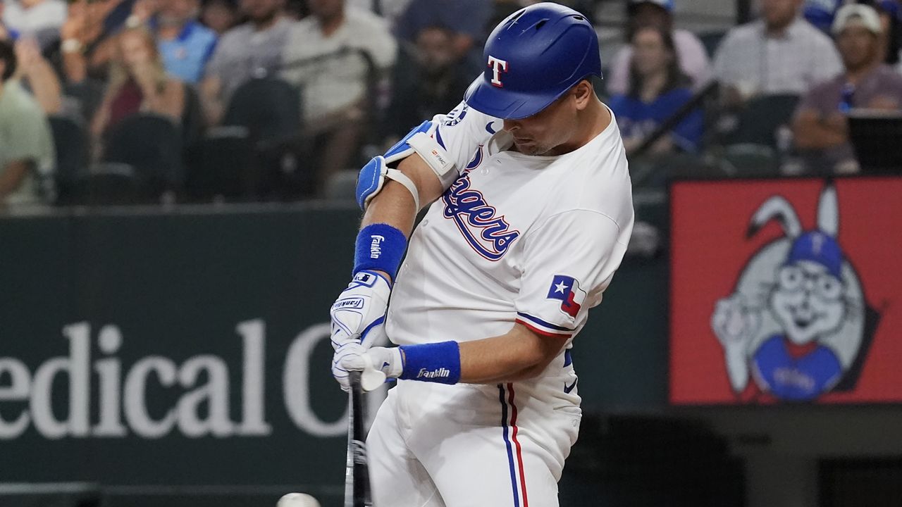 Texas Rangers Nathaniel Lowe hits a home run during the third inning of a baseball game against the San Diego Padres in Arlington, Texas, Tuesday, July 2, 2024. Texas Rangers Josh Smith also scored on the play. (AP Photo/LM Otero)