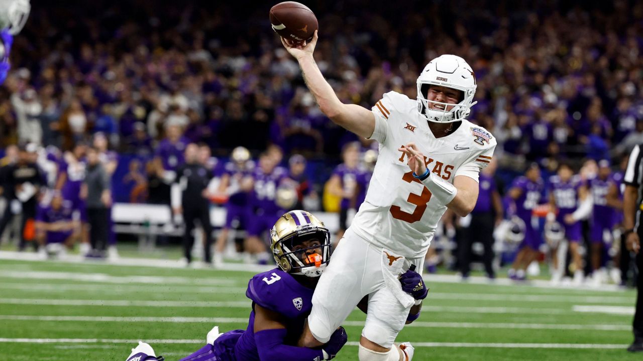 Texas quarterback Quinn Ewers (3) is tackled by Washington safety Mishael Powell (3) as he throws the ball during the second half of an NCAA college football game Monday, Jan. 1, 2024, in New Orleans. (AP Photo/Butch Dill, File)