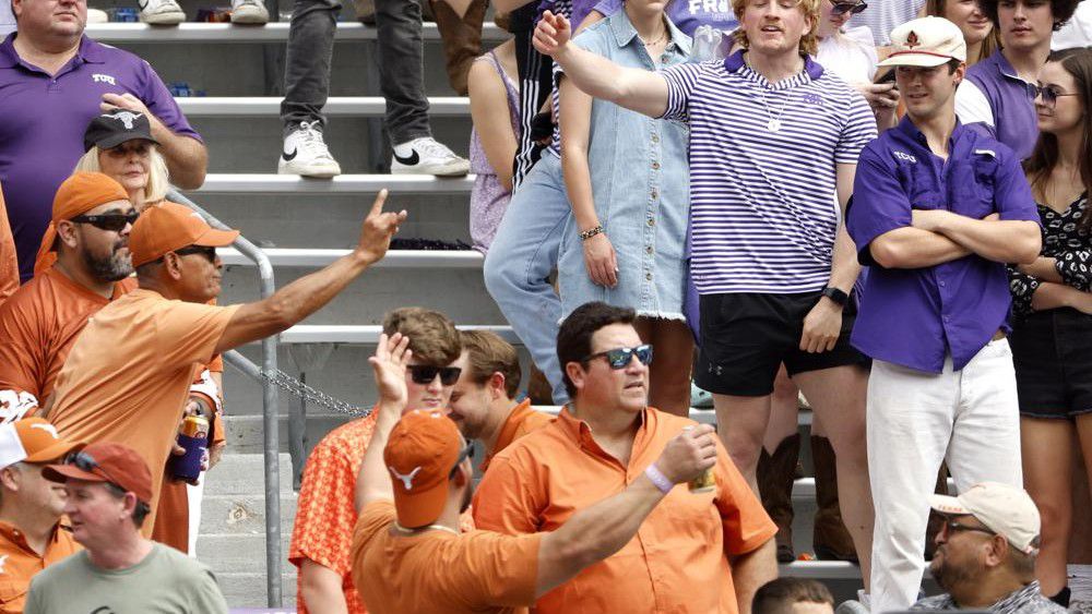 Texas and TCU fans let their feelings show during the second half of an NCAA college football game Saturday, Oct. 2, 2021, in Fort Worth, Texas. Texas won 32-27. (AP Photo/Ron Jenkins)