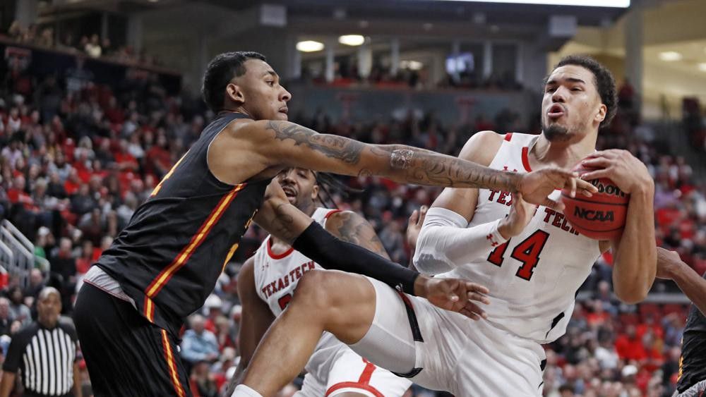 Texas Tech's Marcus Santos-Silva (14) rebounds the ball away from Grambling State's AJ Taylor (14) during the first half of an NCAA college basketball game against Grambling State, Friday, Nov. 12, 2021, in Lubbock, Texas. (Brad Tollefson/Lubbock Avalanche-Journal via AP)