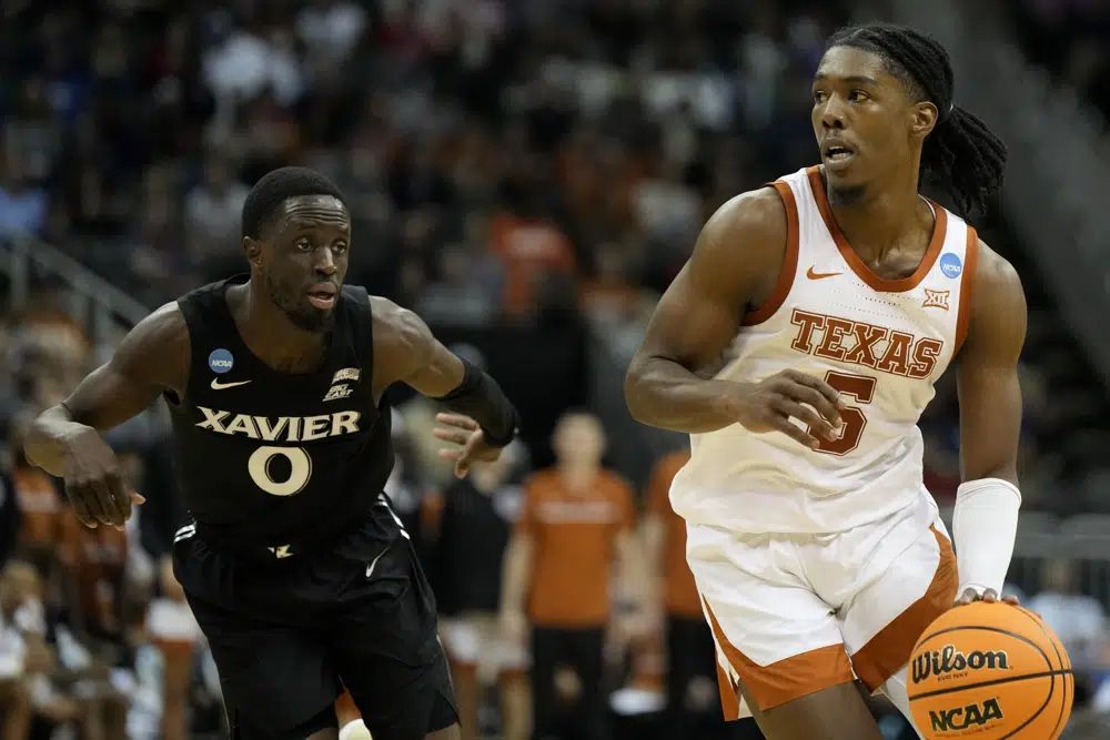 Texas guard Marcus Carr drives to the basket past Xavier guard Souley Boum in the first half of a Sweet 16 college basketball game in the Midwest Regional of the NCAA Tournament Friday, March 24, 2023, in Kansas City, Mo. (AP Photo/Jeff Roberson)