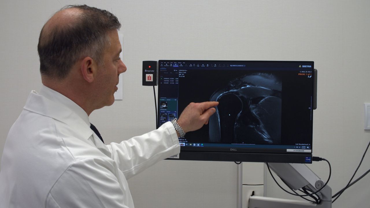 Dr. Joshua Dines pointing at an x-ray (Spectrum News)