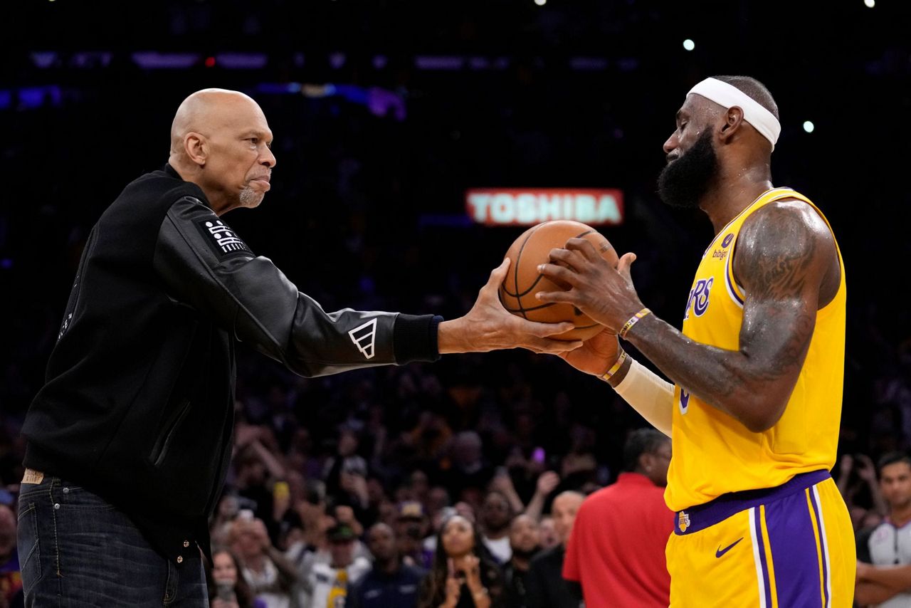 NBA Commissioner David Stern, center holding the ball, poses for a