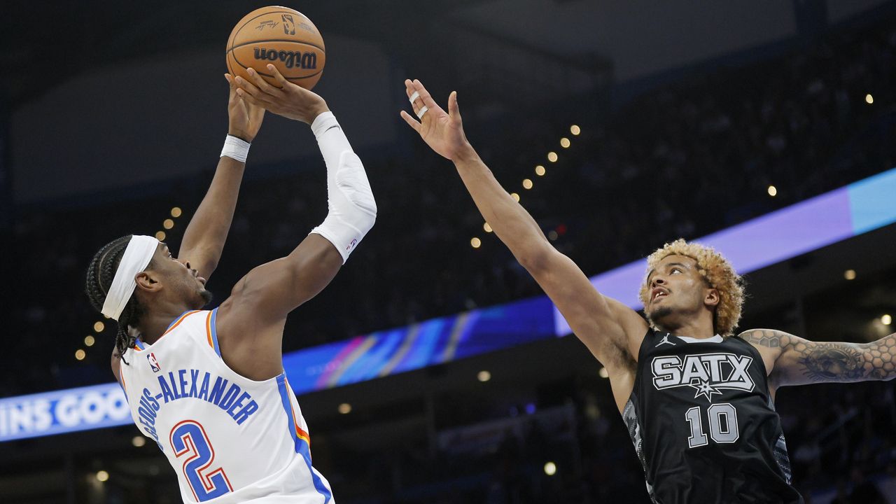 Oklahoma City Thunder guard Shai Gilgeous-Alexander (2) shoots against San Antonio Spurs forward Jeremy Sochan (10) during the second half of an NBA basketball game, Wednesday, Oct. 30, 2024, in Oklahoma City. (AP Photo/Nate Billings)