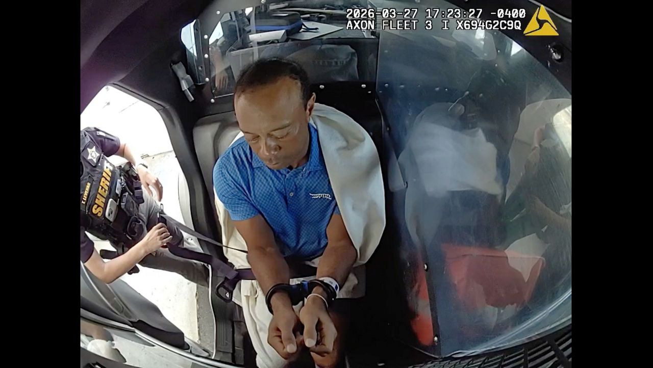 Bodycam shows a stunned Tiger Woods handcuffed after a Florida rollover ...