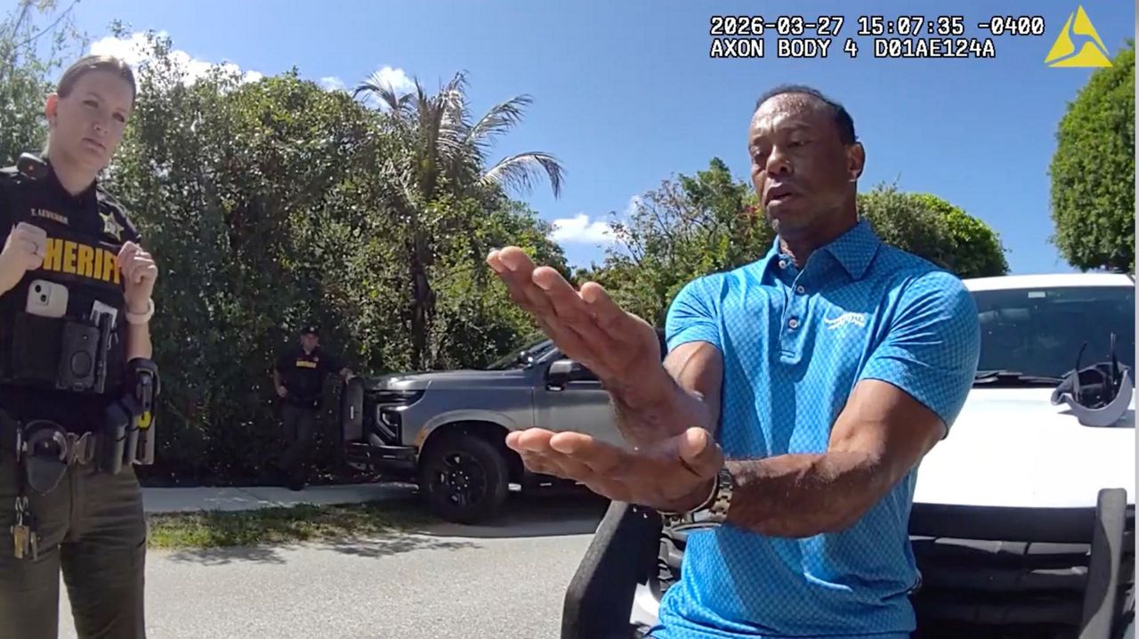 Bodycam shows a stunned Tiger Woods handcuffed after a Florida rollover ...