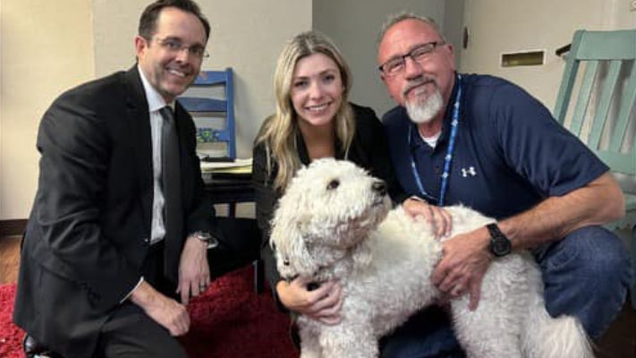 McLennan County assistant district attorneys Ryan Calvert (left) and Alyssa Killin (center) and investigator Keith Kunz (right) take a picture with Mandy Rose Reynolds' dog, Titan. (McLennan County District Attorney's Office)