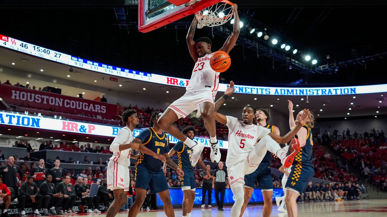 Houston guard Terrance Arceneaux (23) dunks during the second half of an NCAA college basketball game against the Toledo in Houston, Wednesday, Dec. 18, 2024. (AP Photo/Ashley Landis)