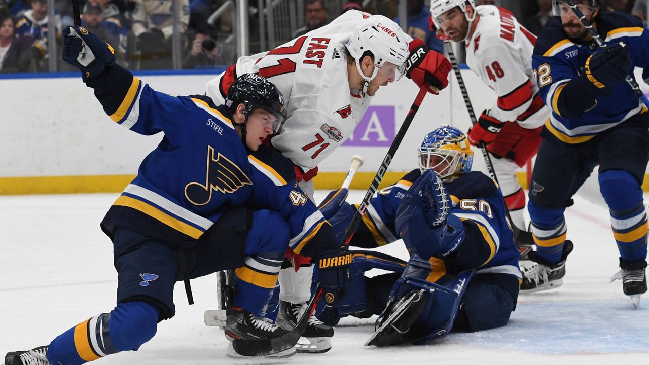 Carolina Hurricanes' Jesper Fast (71) attempts a shot on goal against St. Louis Blues' Torey Krug (47) and Jordan Binnington (50) during the first period of an NHL hockey game Thursday, Dec. 1, 2022, in St. Louis. (AP Photo/Michael Thomas)