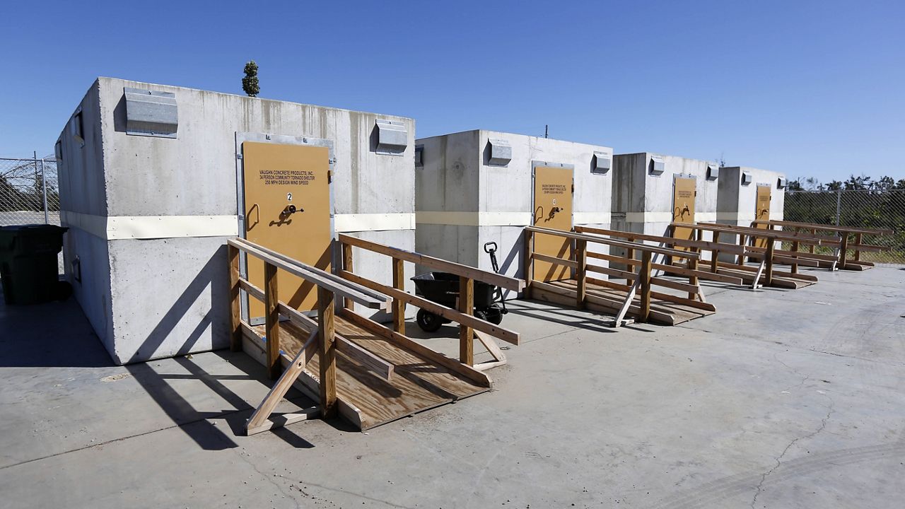 In this Oct. 15, 2014 photo, a row of tornado shelters sit outside a temporary hospital in Louisville, Miss.