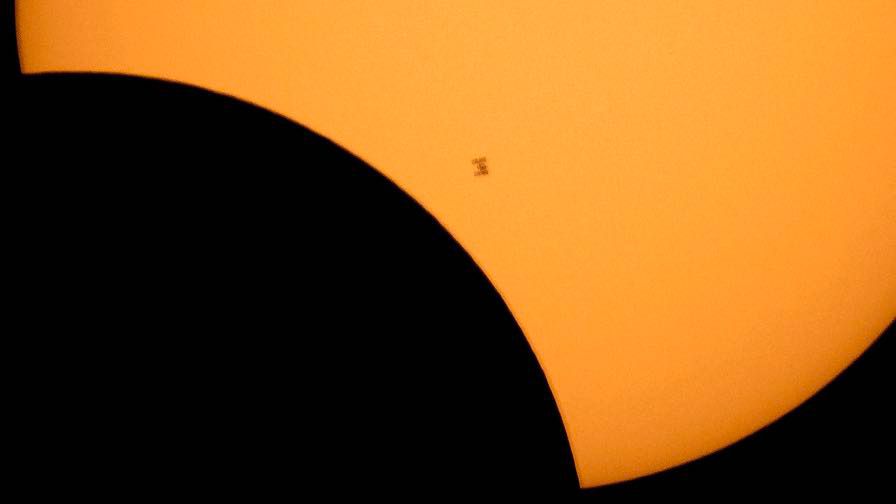 The International Space Station is silhouetted against the sun during a solar eclipse Monday, Aug. 21, 2017, as seen from Ross Lake, Northern Cascades National Park in Washington state. (Bill Ingalls/NASA via AP, File)