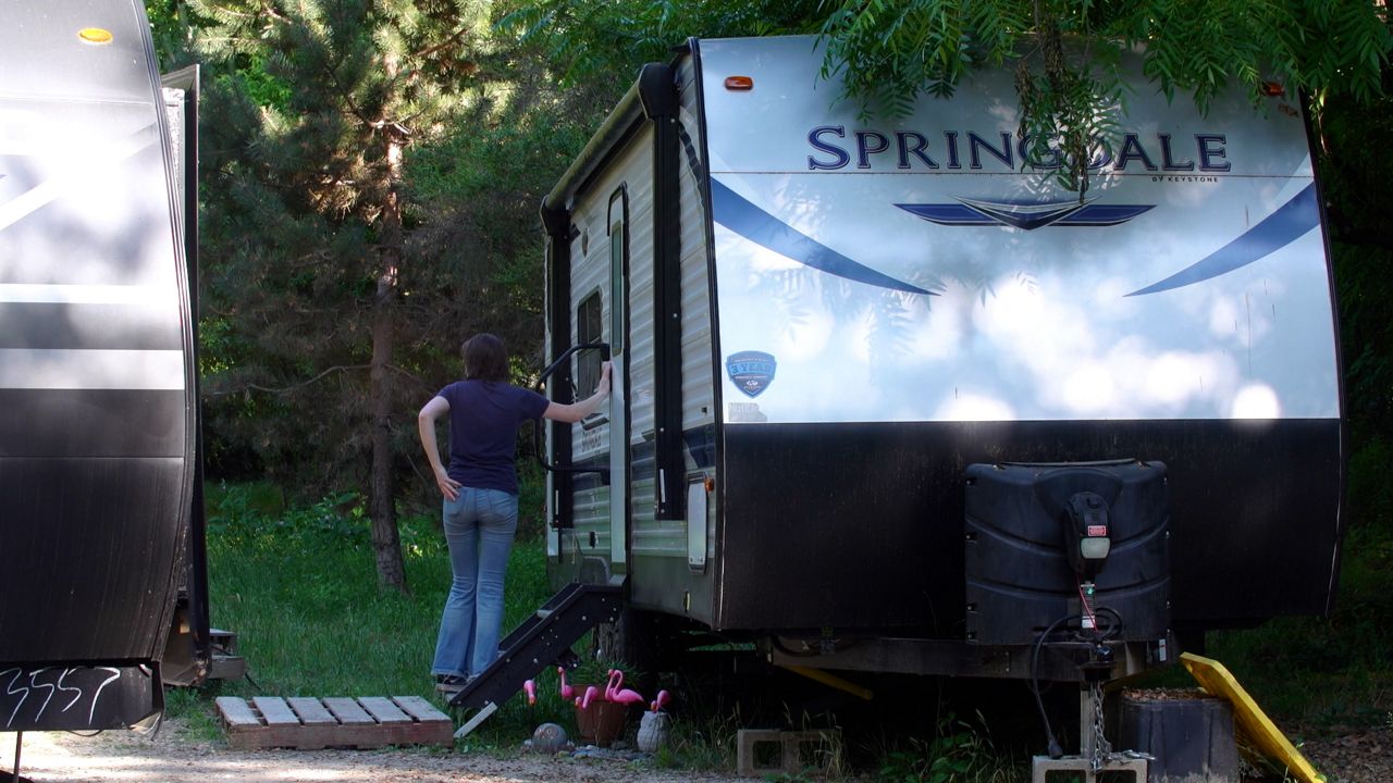 Nathalie Dervaux and her familiy have been living in two trailers on their property for several months while waiting for their home repairs. (Spectrum News)