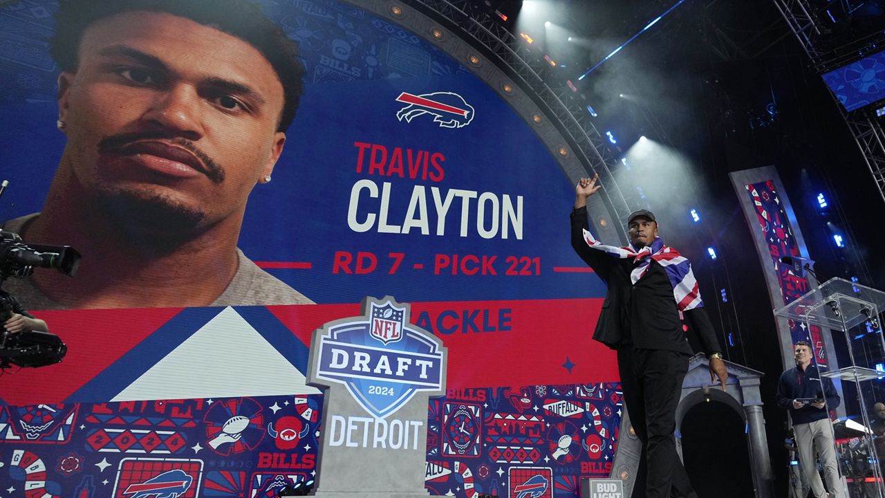 Travis Clayton reacts after being picked by the Buffalo Bills with the 221st overall pick in the seventh round during the third day of the NFL football draft, Saturday, April 27, 2024, in Detroit. (AP Photo/Jeff Roberson)