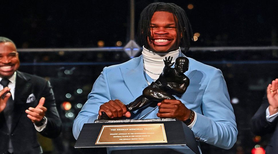 Colorado’s Travis Hunter holds the trophy after winning the Heisman Trophy as the outstanding player in college football, Saturday, Dec. 14, 2024, in New York. (Todd Van Emst/Heisman Trust via AP, Pool)