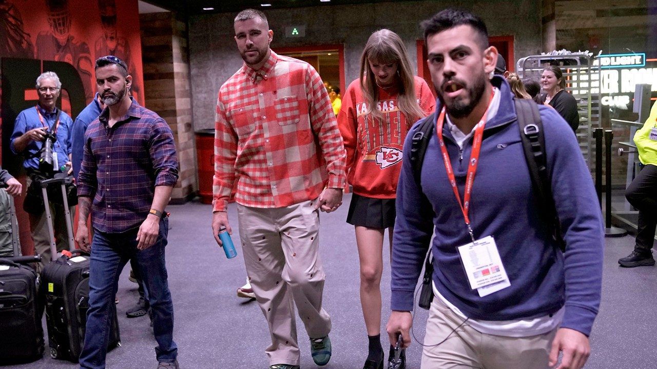 Kansas City Chiefs tight end Travis Kelce, center left, and singer Taylor Swift leave Arrowhead stadium after an NFL football game between the Chiefs and the Los Angeles Chargers, Sunday, Oct. 22, 2023, in Kansas City, Mo. (AP Photo/Charlie Riedel)