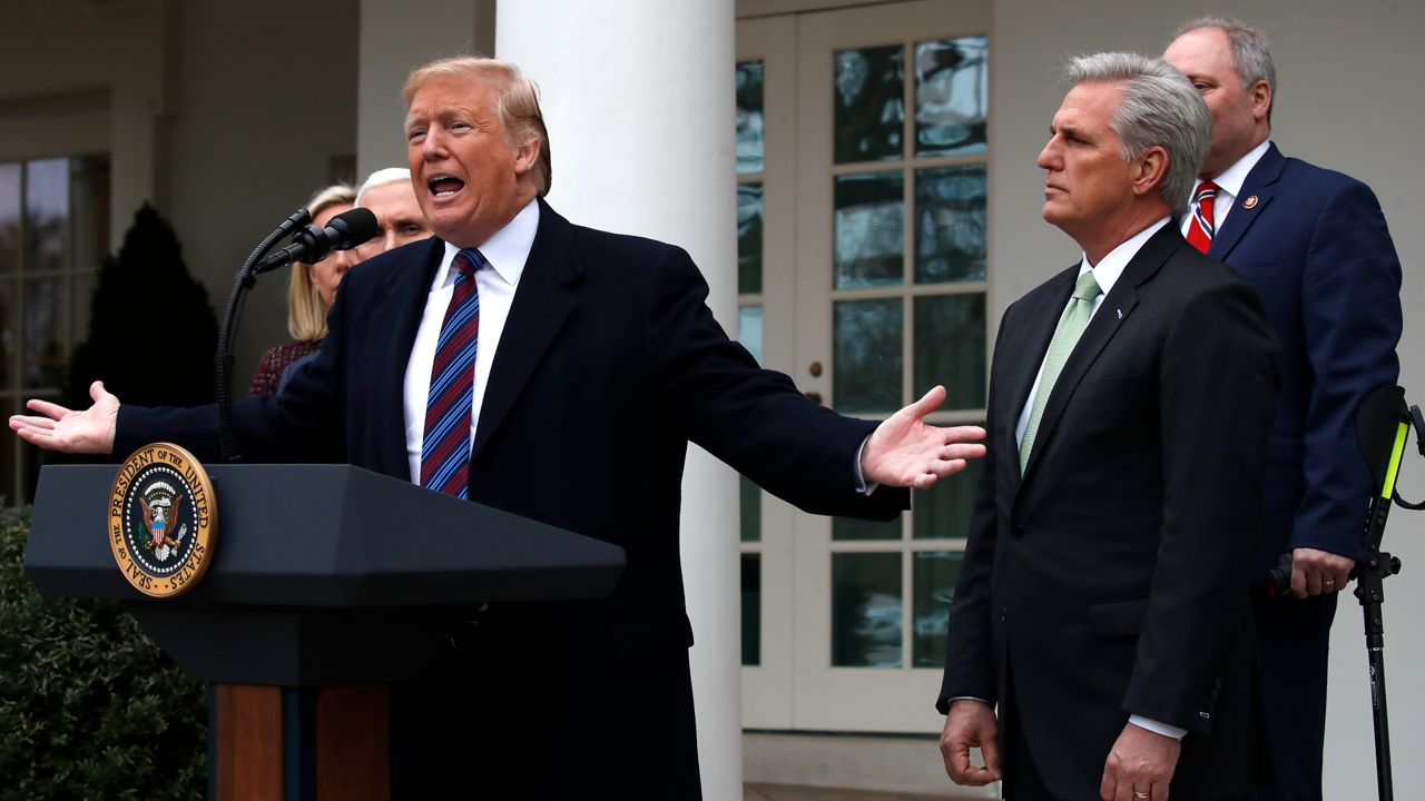 President Donald Trump speaks in the Rose Garden of the White House, as from left, Homeland Security Secretary Kirstjen Nielsen, Vice President Mike Pence, House Minority Leader Kevin McCarthy of Calif., and House Minority Whip Steve Scalise of La., listen, after a meeting with Congressional leaders on border security, Friday, Jan. 4, 2019, at the White House in Washington. (AP Photo/Jacquelyn Martin)