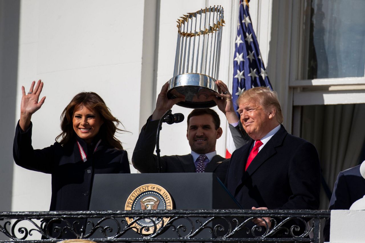 President Donald Trump, left, reacts as Washington Nationals catcher Kurt  Suzuki walks to a podium to speak during an event to honor the 2019 World  Series champion Nationals at the White House