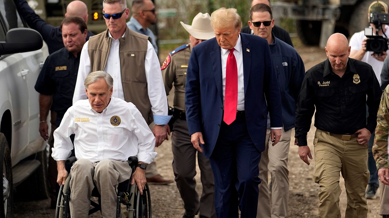 Republican presidential candidate former President Donald Trump talks with Texas Gov. Greg Abbott during a visit to the U.S.-Mexico border at Shelby Park, Thursday, Feb. 29, 2024, in Eagle Pass, Texas. (AP Photo/Eric Gay)