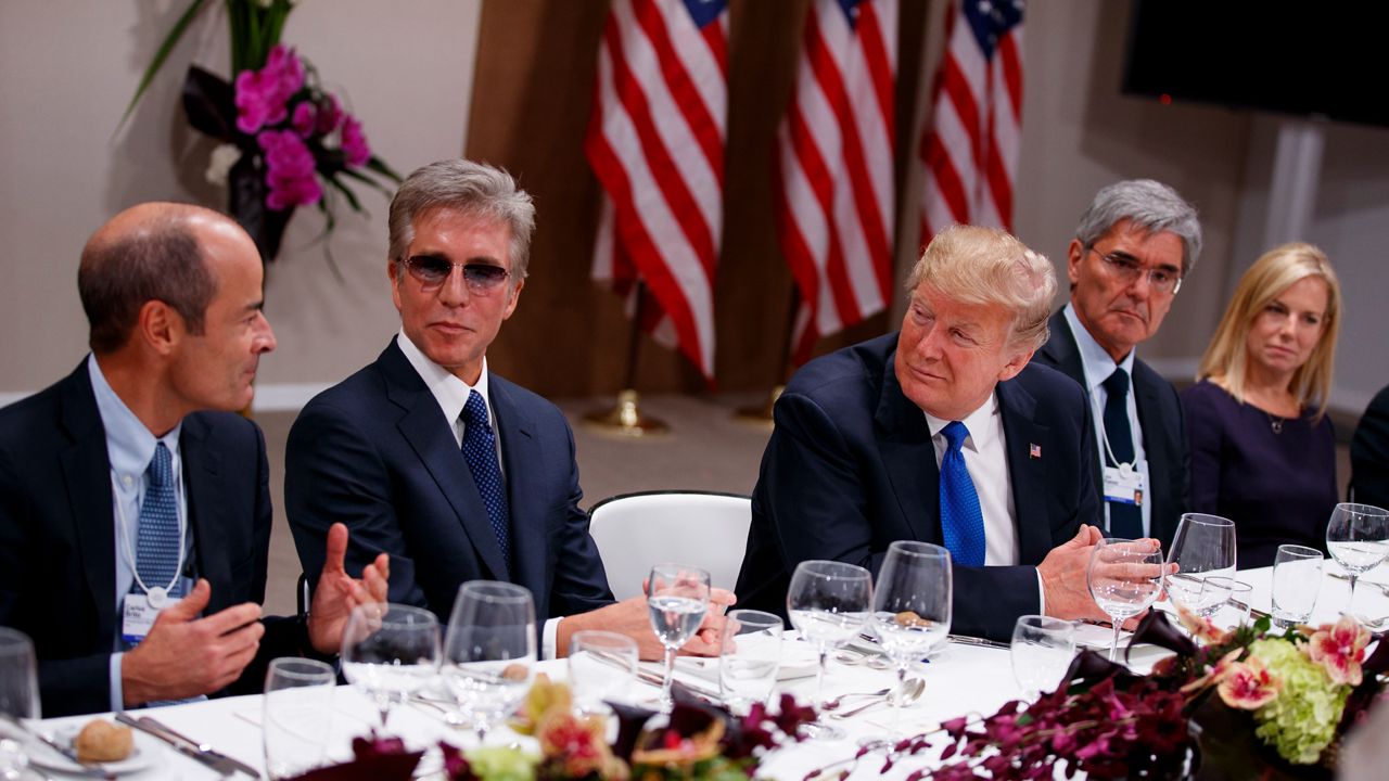 Then-President Donald Trump listens during a dinner with European business leaders at the World Economic Forum, Thursday, Jan. 25, 2018, in Davos. From left, CEO of Anheuser-Busch InBev Carlos Brito, SAP CEO Bill McDermott, Trump, CEO of Seimens Joe Kaeser, and Secretary of Homeland Security Kirstjen Nielsen. (AP Photo/Evan Vucci)