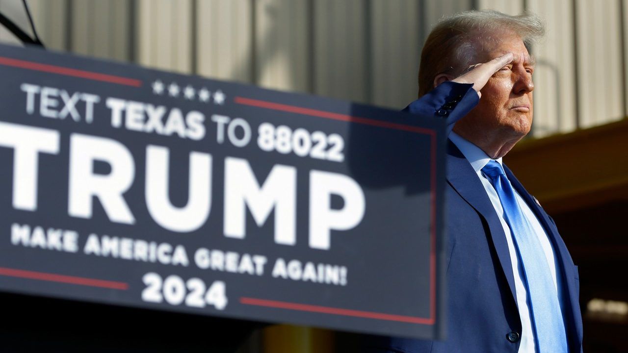 Former President Donald Trump salutes during patriotic music before he gives remarks during a campaign event held at Trendsetter Engineering, Thursday, Nov. 2, 2023, in Houston. (AP Photo/Michael Wyke)