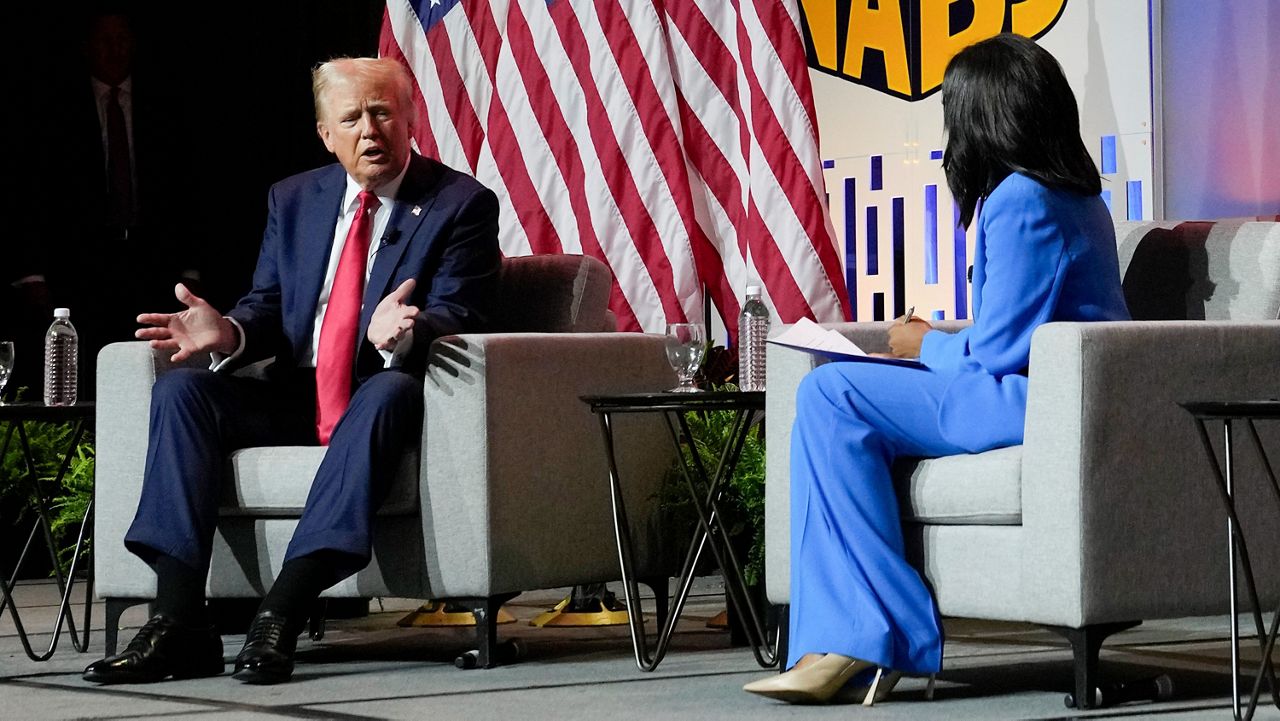 Republican presidential candidate former President Donald Trump, left, moderated by ABC's Rachel Scott, speaks at the National Association of Black Journalists convention, July 31, 2024, in Chicago. The backlash against Trump's attack on Vice President Kamala Harris' racial identity intensified on Thursday. Democrats expressed new outrage and some Republicans distanced themselves from Trump's comments that Harris only recently "turned Black" for political gain. Harris is of Jamaican and Indian heritage. Trump shrugged off the criticism and doubled down by posting on social media a new picture depicting Harris in traditional Indian garb. (AP Photo/Charles Rex Arbogast, File)