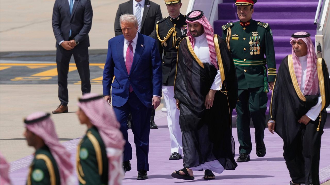 President Donald Trump walks with Saudi Crown Prince Mohammed bin Salman during an arrival ceremony at the Royal Terminal of King Khalid International Airport in Riyadh, Saudi Arabia, Tuesday, May 13, 2025.(AP Photo/Alex Brandon)
