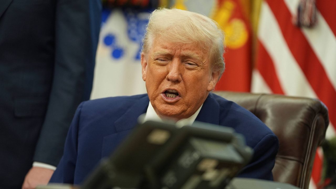 President Donald Trump speaks on the phone to Britain's Prime Minister Keir Starmer about a trade deal between the U.S. and United Kingdom in the Oval Office of the White House, Thursday, May 8, 2025, in Washington. (AP Photo/Evan Vucci)