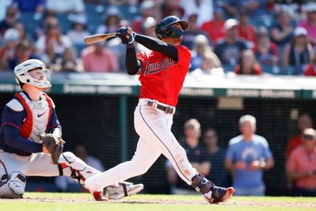 Cleveland Guardians right fielder Oscar Gonzalez flips his bat