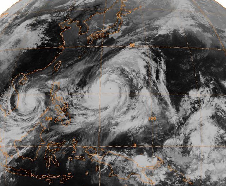 Satellite image of Typhoon Tip (center) near peak intensity, with Typhoon Sarah (left) near Vietnam.