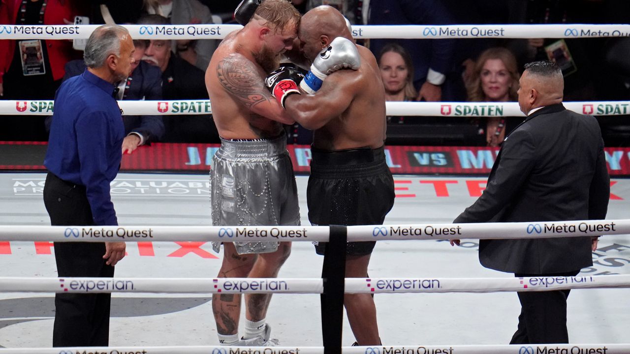 Jake Paul, left, and Mike Tyson embrace after their heavyweight boxing match, Friday, Nov. 15, 2024, in Arlington, Texas. (AP Photo/Julio Cortez)