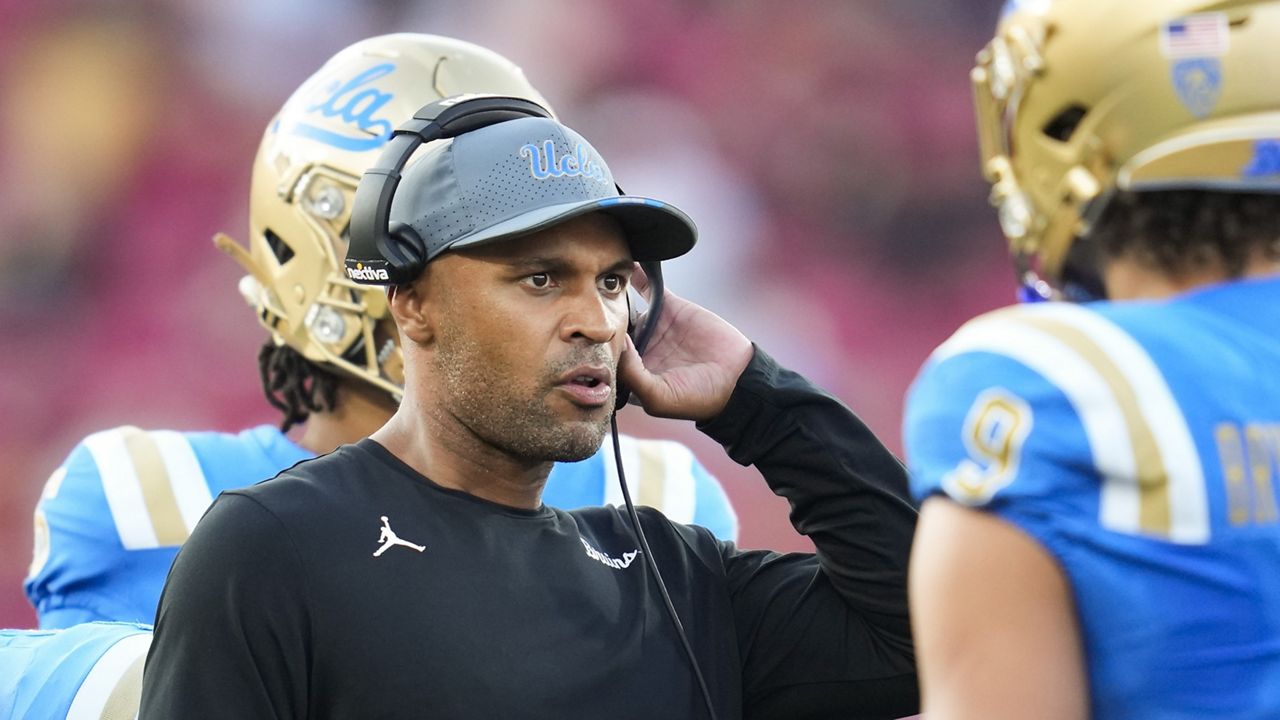 UCLA defensive coordinator D'Anton Lynn talks with linebacker Choe Bryant-Strother (9) during a timeout during the second half of an NCAA college football game against Southern Californiain Los Angeles, Saturday, Nov. 18, 2023. (AP Photo/Ashley Landis)