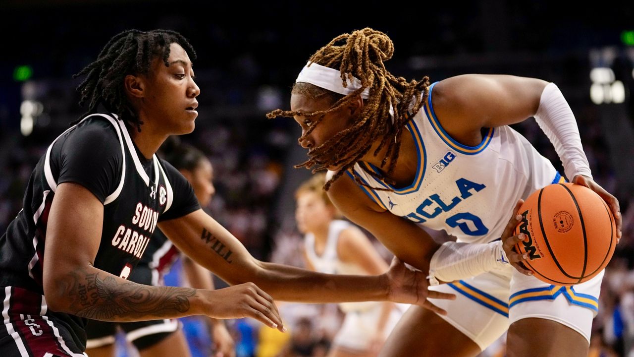 UCLA forward Janiah Barker (0) drives against South Carolina forward Ashlyn Watkins during the second half of an NCAA college basketball game, Sunday, Nov. 24, 2024, in Los Angeles. (AP Photo/Eric Thayer)