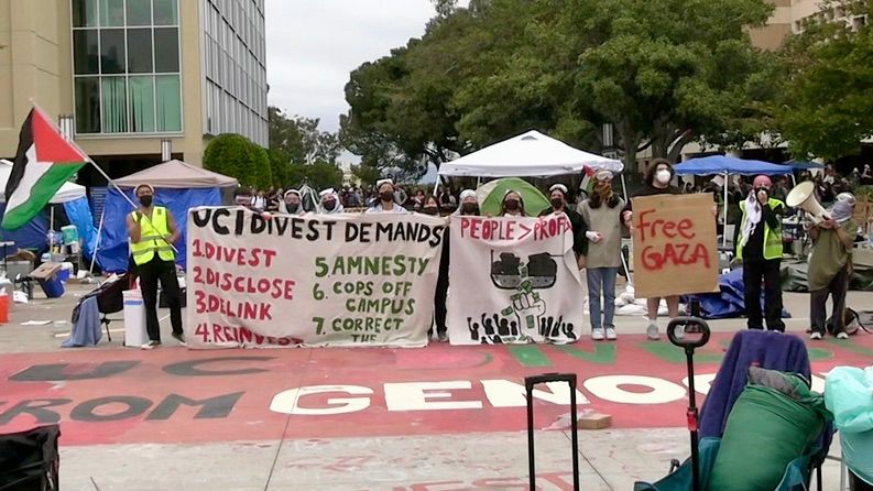 Pro-Palestinian protesters stand in solidarity in the middle of their encampment at UC Irvine. (Spectrum News via OC Hawk) 