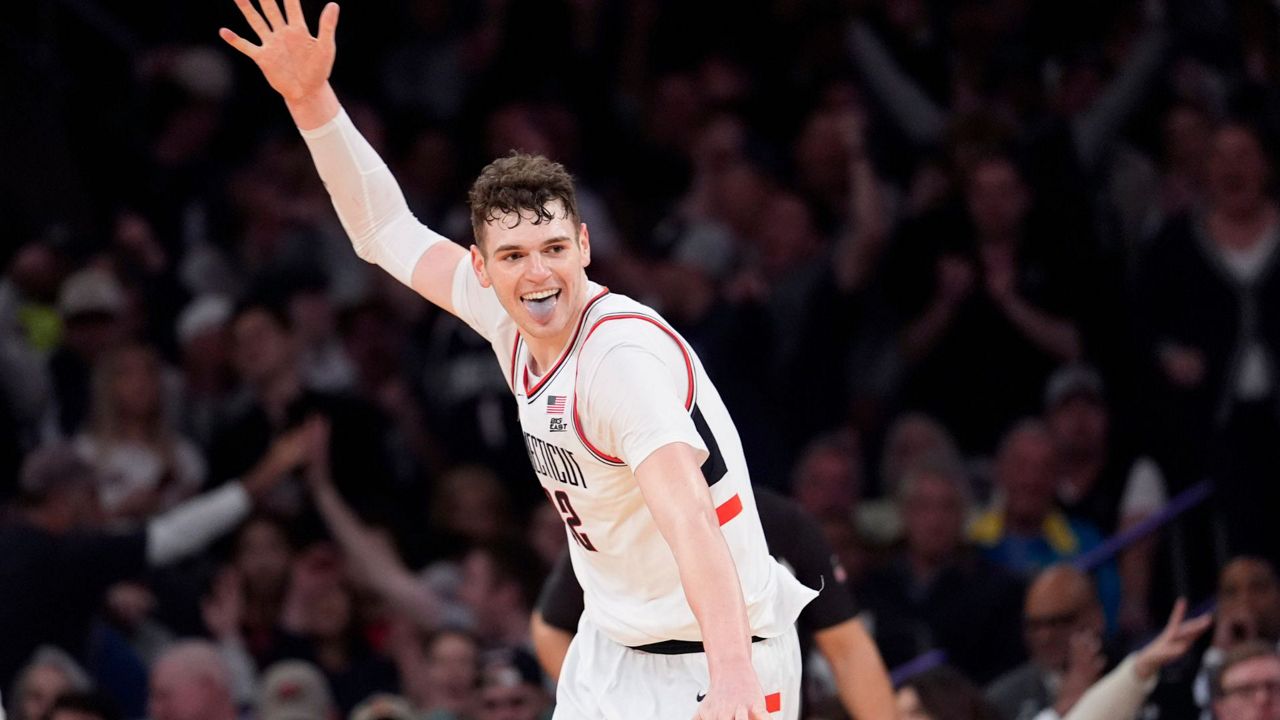 UConn center Donovan Clingan reacts after dunking during the second half of an NCAA college basketball game in the championship against Marquette of the Big East Conference tournament, Saturday, March 16, 2024, in New York. UConn won 73-57. (AP Photo/Mary Altaffer)