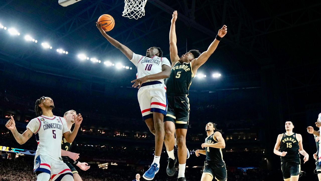 UConn guard Hassan Diarra (10) shoots past Purdue guard Myles Colvin during the second half of the NCAA college Final Four championship basketball game, Monday, April 8, 2024, in Glendale, Ariz. (AP Photo/Brynn Anderson)