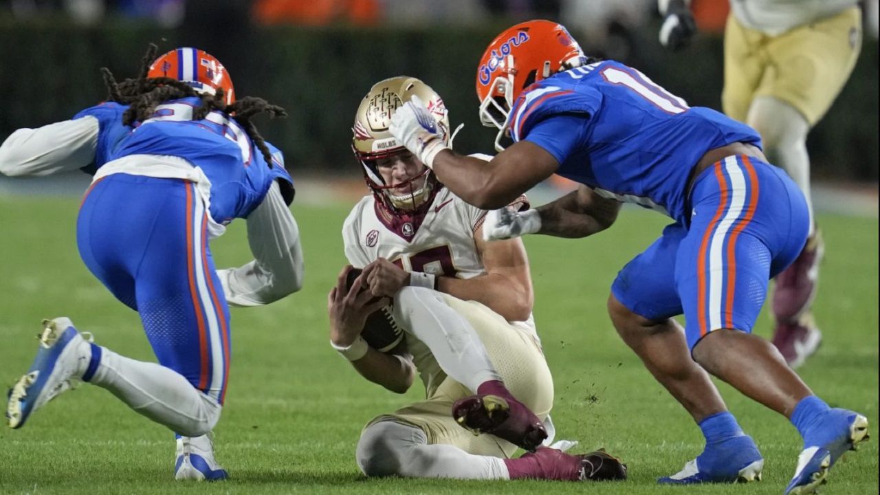 Florida defenders close in on FSU quarterback Tate Rodenmaker (center) during the 2023 Florida-Florida State game. FSU won last year's meeting 24-15. (AP Photo/John Raoux)