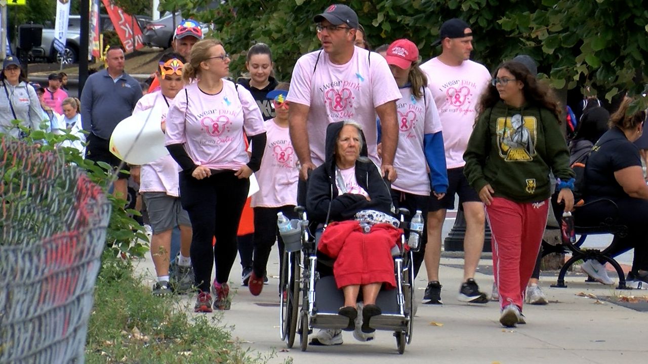 People walk along the route of the UMass Cancer Walk in Worcester on Sunday. (Spectrum News 1/Devin Bates)