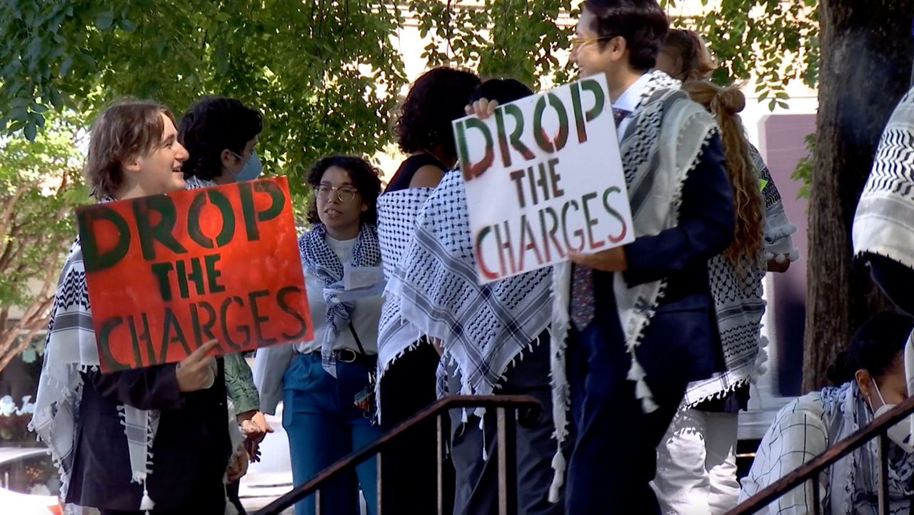 People standing in solidarity with the protesters, who are facing charges, outside the Orange County Courthouse. (Spectrum News 1/Kyleigh Panetta)