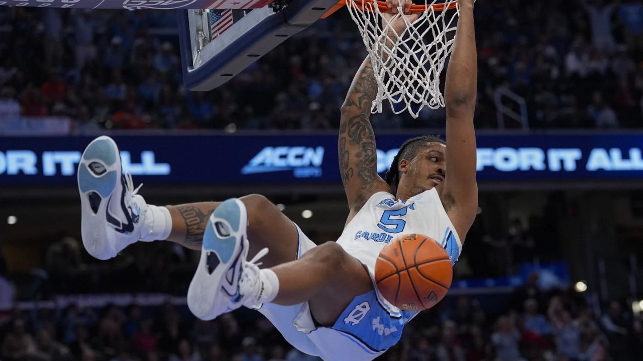 North Carolina forward Armando Bacot (5) hanging from the basket after scoring against Pittsburgh during the first half of an NCAA college basketball game in the semifinal round of the Atlantic Coast Conference tournament Friday, March 15, 2024, in Washington. (AP Photo/Susan Walsh)