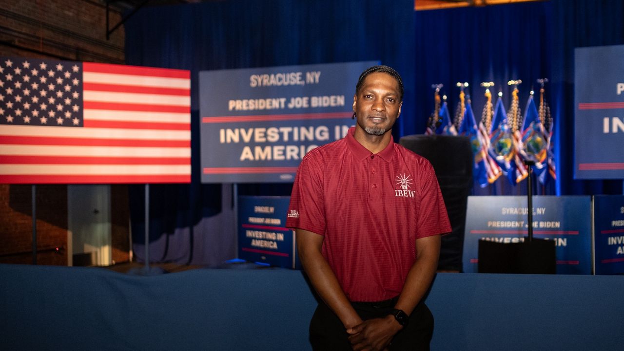 Shannon Thomas stands in front of the podium at President Joe Biden's event in Syracsue. 