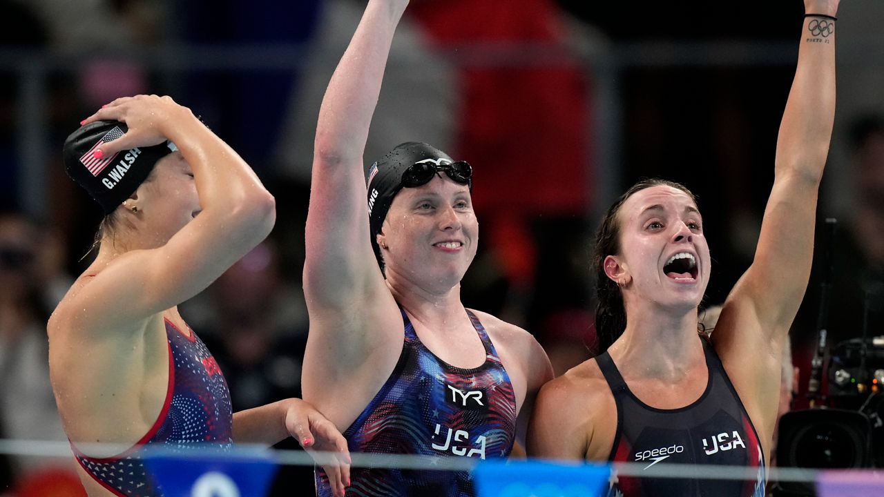 United States' Gretchen Walsh, from left, Lilly King and Regan Smith celebrate winning the gold medal in the women's 4x100-meter medley relay final at the Summer Olympics in Nanterre, France, Sunday, Aug. 4, 2024.(AP Photo/Brynn Anderson)