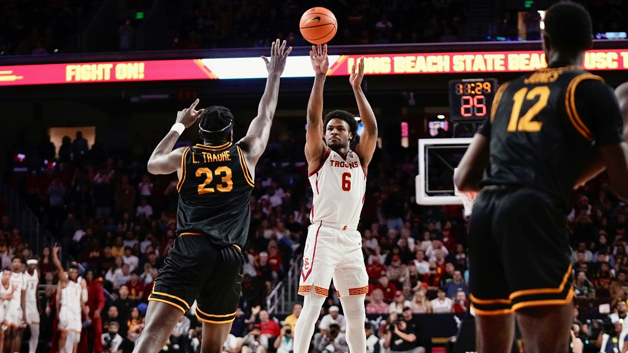 Southern California guard Bronny James (6) shoots as Long Beach State forward Lassina Traore (23) defends during the first half of an NCAA college basketball game Sunday, Dec. 10, 2023, in Los Angeles.