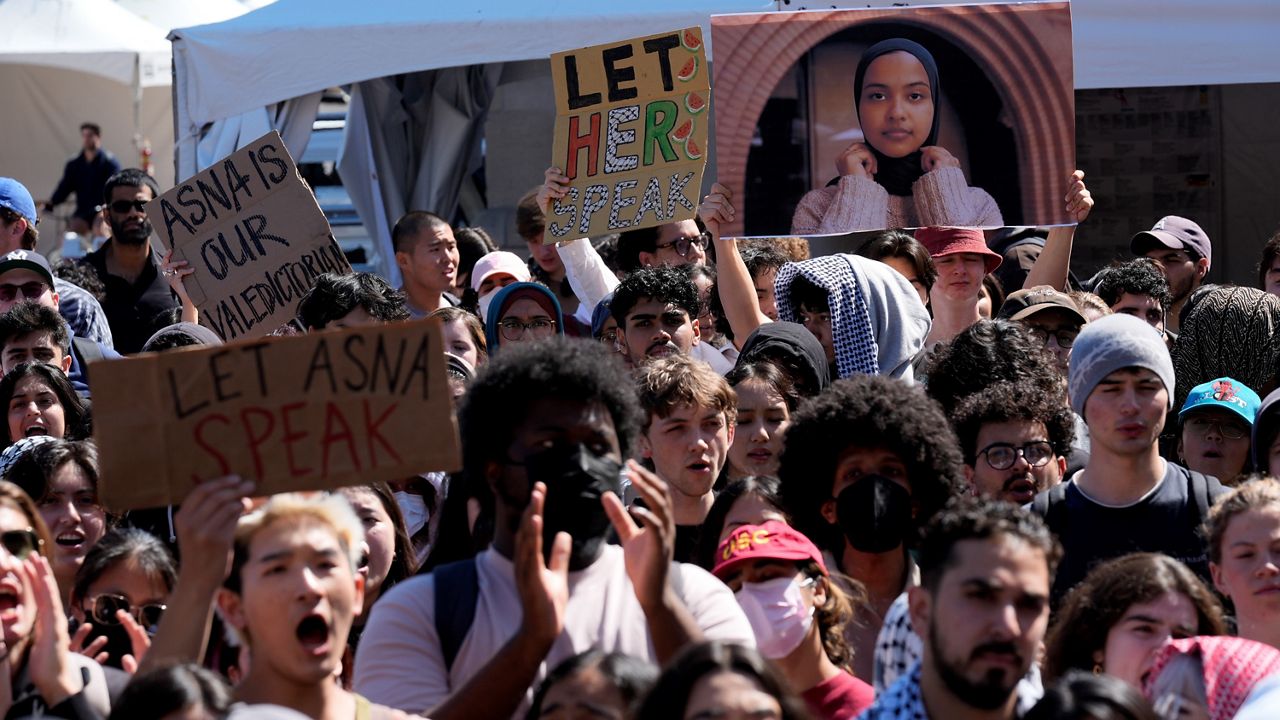 Students protest a canceled commencement speech by its 2024 valedictorian who has publicly supported Palestinians on the campus of University of Southern California, Thursday, April 18, 2024. (AP Photo/Damian Dovarganes)