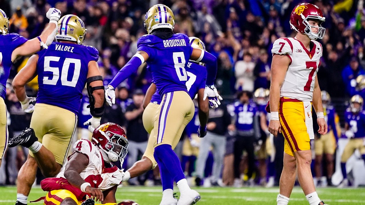 Southern California running back Woody Marks (4) looks toward quarterback Miller Moss (7) after being stopped at the goal line by Washington players, including safety Cameron Broussard (8) and defensive tackle Sebastian Valdez (50), during the second half of an NCAA college football game Saturday, Nov. 2, 2024, in Seattle. (AP Photo/Lindsey Wasson)