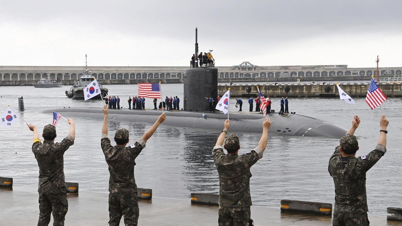 In this photo provided by South Korea Defense Ministry, South Korean navy sailors wave as the USS nuclear-powered submarine USS Annapolis arrives at a South Korean naval base on Jeju Island, South Korea, Monday, July 24, 2023. The nuclear-propelled U.S. submarine has arrived in South Korea in the second deployment of a major U.S. naval asset to the Korean Peninsula this month, South Korea's military said Monday, adding to the allies' show of force to counter North Korean nuclear threats. (South Korea Defense Ministry via AP)